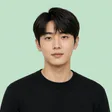 Portrait of a man with dark hair in a black jumper